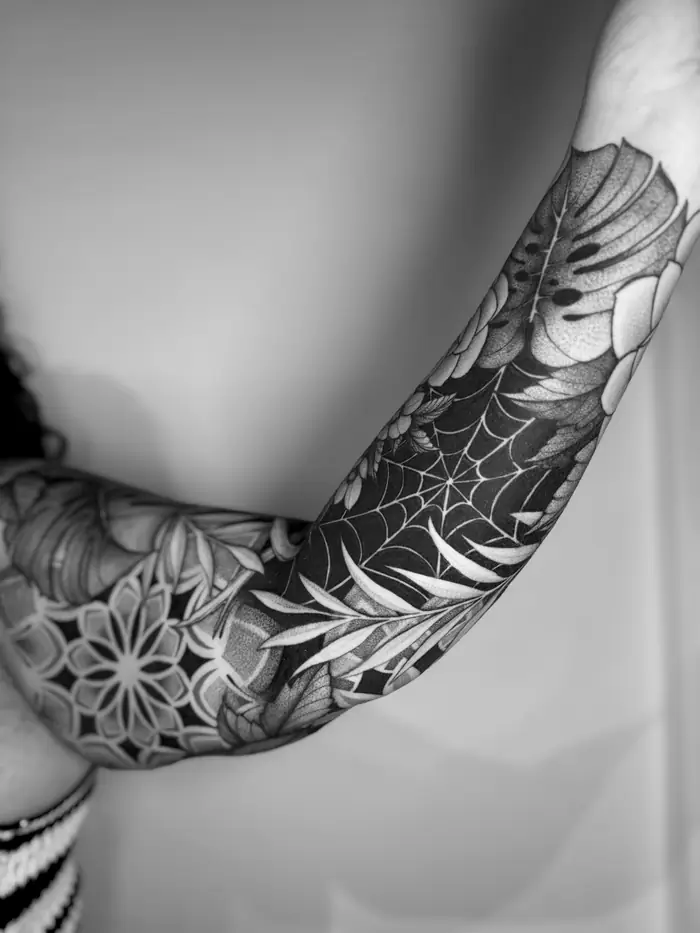 Ornamental sleeve with a mandala and spiderweb