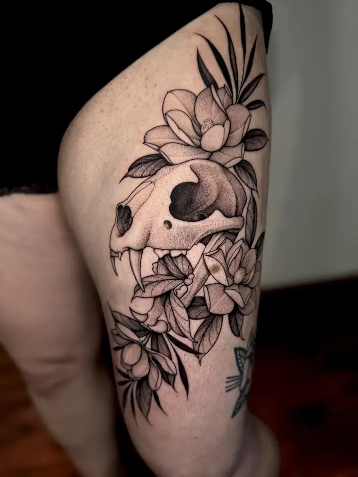 Animal skull with flowers on the thigh
