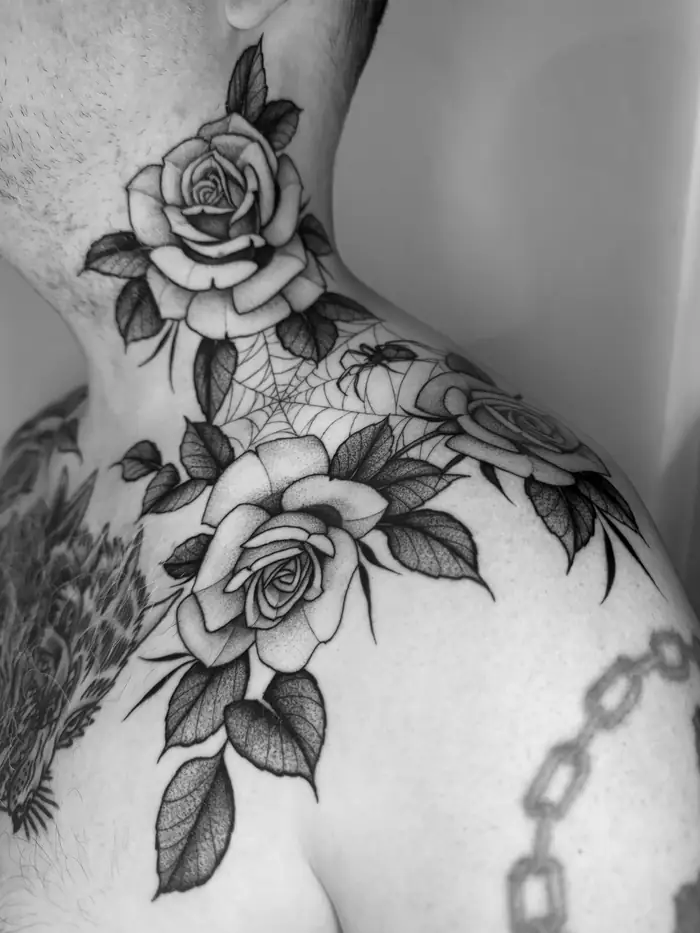 Roses and a spiderweb on the neck and shoulder
