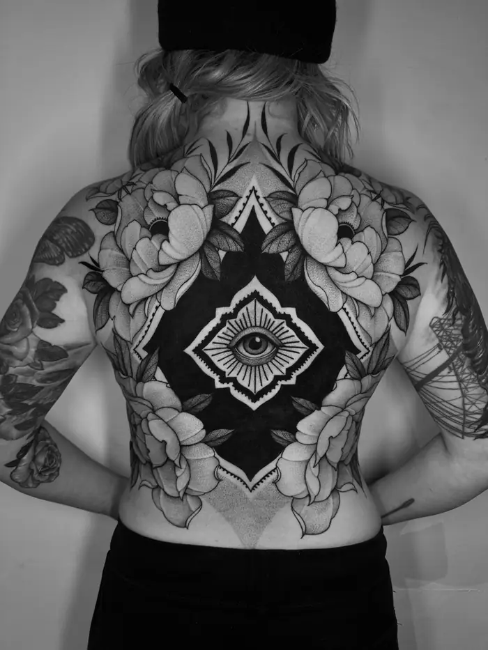 Backpiece with peonies around a central eye